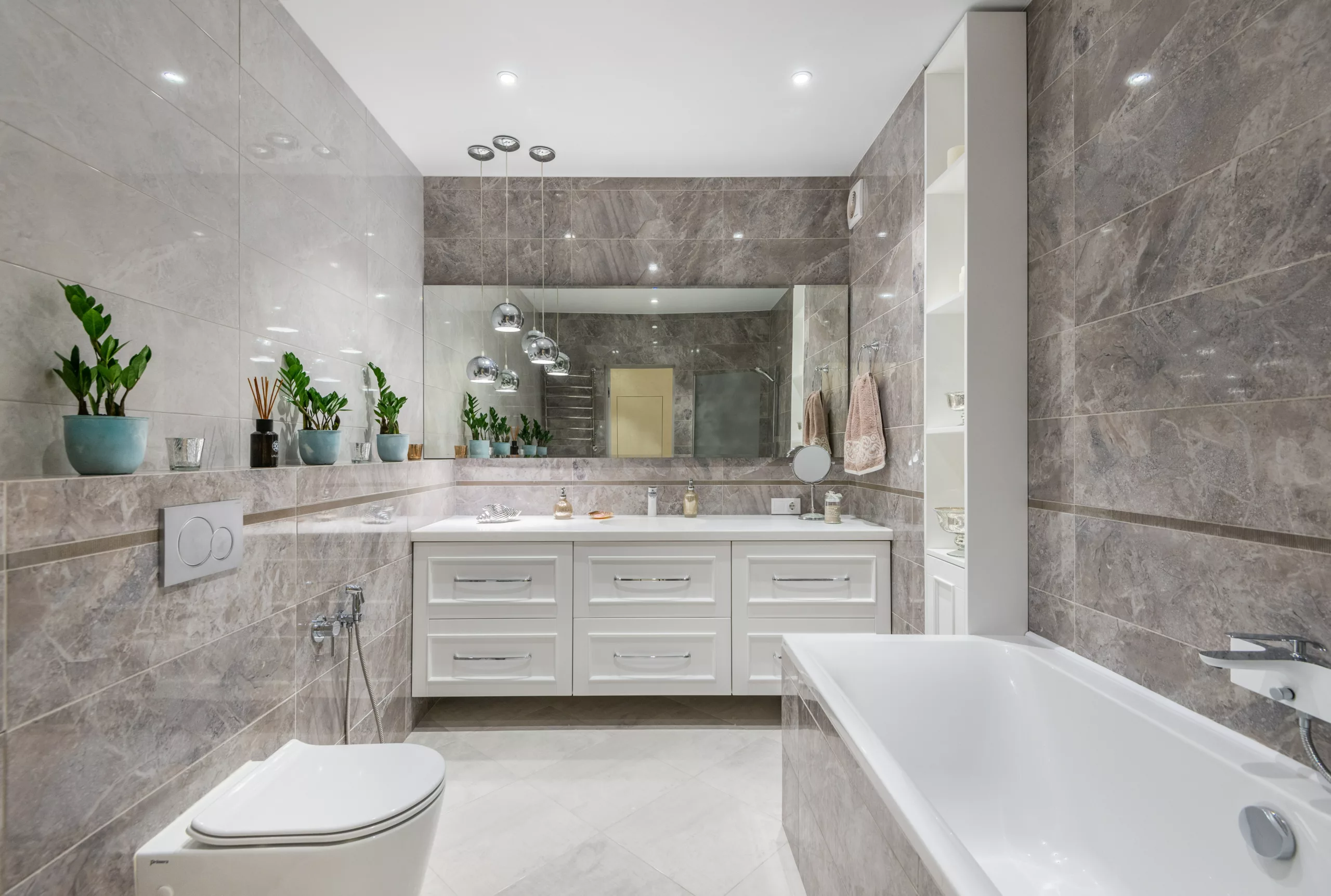bathroom-renovation-white-cabinetry-big-mirror-white-ceiling-downlights-silver-dome-hanging-lights-champagne-marbled-wall-tiles-floor-big-square-beige-tiles
